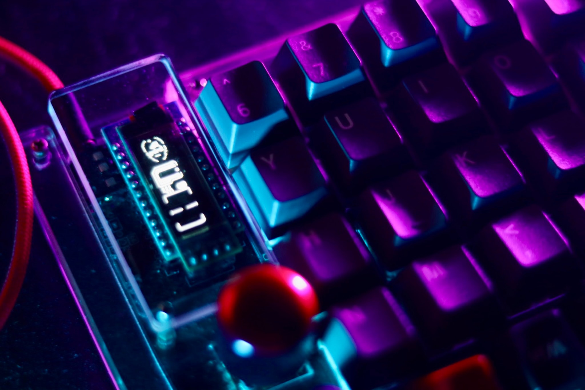 The image features an Arduino Uno board with a USB cable attached to it. The board has a digital display showing the number "1024". Surrounding the board, there are several colorful keyboard keys, suggesting that this setup may be related to a project involving electronics and computer hardware.